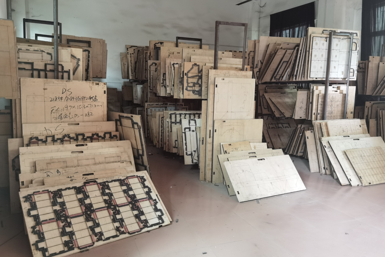 Factory die-cut boards and custom structure templates used in board game manufacturing